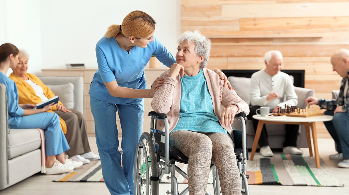 Nurses assisting elderly people at retirement home